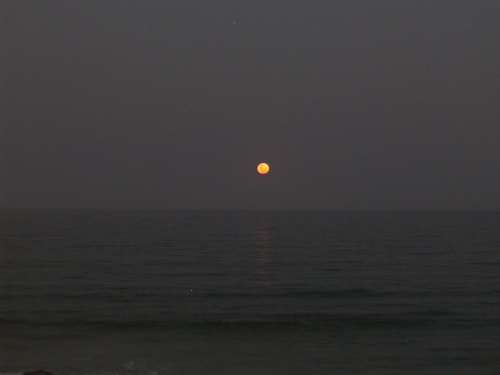 moon setting over ocean  photography