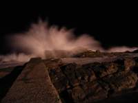 ocean waves breaking on rocks at night 1 